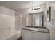 Bathroom featuring a shower and tub, granite countertop vanity, and a well-lit mirror at 5450 Bentgrass Dr # 5-301, Sarasota, FL 34235