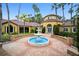 Charming courtyard showcasing a tiered fountain and Mediterranean-style architecture with lush landscaping at 5450 Bentgrass Dr # 5-301, Sarasota, FL 34235