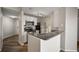 Modern kitchen with stainless steel appliances and a granite countertop breakfast bar at 5450 Bentgrass Dr # 5-301, Sarasota, FL 34235