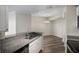 Stylish kitchen view with stone counters and eat in bar, seamlessly connecting to the dining area at 5450 Bentgrass Dr # 5-301, Sarasota, FL 34235
