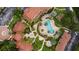 Aerial view of community pool, landscaping, fountains, and buildings with terracotta tile roofs at 5450 Bentgrass Dr # 5-301, Sarasota, FL 34235