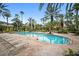 Beautiful community pool surrounded by lush landscaping and lounge chairs for relaxing by the water at 5450 Bentgrass Dr # 5-301, Sarasota, FL 34235