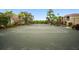 Well-maintained tennis court with a net, surrounded by landscaping and trees; a bench and bike rack are visible at 5450 Bentgrass Dr # 5-301, Sarasota, FL 34235