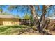 Shady backyard featuring mature trees, a privacy fence, and a rope swing at 5562 Hayden Blvd, Sarasota, FL 34232