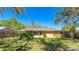 Wide backyard featuring lush greenery, mature trees, and a newly installed fence at 5562 Hayden Blvd, Sarasota, FL 34232