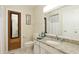 Well-maintained bathroom with granite countertop and mirrored vanity with decorative mirror at 5562 Hayden Blvd, Sarasota, FL 34232