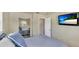 Bedroom featuring a mirrored closet, flat screen TV, and neutral colors at 5562 Hayden Blvd, Sarasota, FL 34232