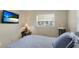 Comfortable bedroom featuring a flat-screen television and natural light at 5562 Hayden Blvd, Sarasota, FL 34232