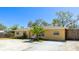 Well-maintained single-story home featuring a palm tree and long driveway at 5562 Hayden Blvd, Sarasota, FL 34232
