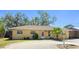 Charming single-story home with a well-manicured lawn, palm tree, and inviting front entrance at 5562 Hayden Blvd, Sarasota, FL 34232