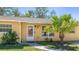 Close-up of a cozy single-story home featuring a decorative front door and manicured landscaping at 5562 Hayden Blvd, Sarasota, FL 34232