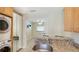 Open kitchen features stainless sink, granite countertop, and convenient laundry area at 5562 Hayden Blvd, Sarasota, FL 34232