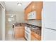 Functional kitchen featuring light wood cabinets, granite countertops, and modern appliances at 5562 Hayden Blvd, Sarasota, FL 34232