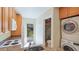 Kitchen featuring granite counters, yard access, and stackable washer/dryer in the room at 5562 Hayden Blvd, Sarasota, FL 34232
