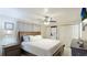 Well-lit main bedroom with ceiling fan, ensuite laundry, and abundant closet space at 5562 Hayden Blvd, Sarasota, FL 34232