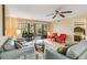 Cozy living room with light blue sofas and a view of the screened outdoor patio at 5568 Ashton Lake Dr # 5568, Sarasota, FL 34231