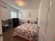 Bedroom with a colorful comforter, white walls, a window and carpet at 5838 Elegant Orchid Way, Sarasota, FL 34232