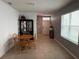 Bright dining room with tile flooring, gray walls, a wooden dining table, and natural light at 5838 Elegant Orchid Way, Sarasota, FL 34232