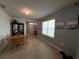 Inviting living room area with natural light, neutral color palette, and dining table near the front entrance at 5838 Elegant Orchid Way, Sarasota, FL 34232
