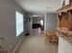 Open-concept dining and living area with tile flooring, gray walls, and natural light at 5838 Elegant Orchid Way, Sarasota, FL 34232