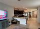 Open-concept living space seamlessly connects the kitchen, dining area, and living room for modern living at 5838 Elegant Orchid Way, Sarasota, FL 34232