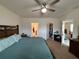 Main bedroom with fan, walk-in closet, and ensuite bathroom at 5838 Elegant Orchid Way, Sarasota, FL 34232