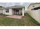 Outdoor covered patio featuring a brick paver floor, ideal for entertaining, and privacy fencing in the backyard at 5838 Elegant Orchid Way, Sarasota, FL 34232