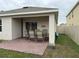 Outdoor covered patio featuring a brick paver floor, ideal for entertaining, and privacy fencing in the backyard at 5838 Elegant Orchid Way, Sarasota, FL 34232