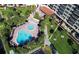 Aerial view of resort-style pool and lounge area with chairs surrounded by lush landscaping at 5855 Midnight Pass Rd # 303, Sarasota, FL 34242