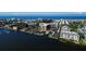 Stunning aerial perspective of waterfront condos, marina, tennis courts, and scenic coastal views at 5855 Midnight Pass Rd # 303, Sarasota, FL 34242