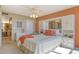 Cozy bedroom featuring built-in storage, mirrored accents, and stylish ceiling fan for optimal comfort at 5855 Midnight Pass Rd # 303, Sarasota, FL 34242