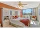 Cozy bedroom boasts a ceiling fan, built-in storage, and beautiful outdoor views at 5855 Midnight Pass Rd # 303, Sarasota, FL 34242