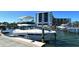 Luxury yacht docked at a private marina slip, with a building in the background at 5855 Midnight Pass Rd # 303, Sarasota, FL 34242