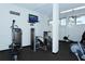Community gym with various exercise machines and a mounted television for entertainment at 5855 Midnight Pass Rd # 303, Sarasota, FL 34242