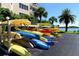 Colorful kayaks and paddleboards stacked on a rack near the water at 5855 Midnight Pass Rd # 303, Sarasota, FL 34242