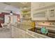 Bright kitchen features granite counters, white cabinetry, and modern appliances at 5855 Midnight Pass Rd # 303, Sarasota, FL 34242
