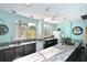 Bright kitchen featuring granite countertops, natural lighting, and ample space for cooking and entertaining at 5855 Midnight Pass Rd # 303, Sarasota, FL 34242