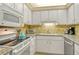 Efficient kitchen with sleek appliances, granite countertops, and ample cabinet space, ideal for cooking and meal preparation at 5855 Midnight Pass Rd # 303, Sarasota, FL 34242