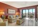 Bright living room with comfortable seating and a balcony with a lovely view at 5855 Midnight Pass Rd # 303, Sarasota, FL 34242