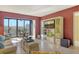 Living room with modern furnishings and a balcony overlooking a beautiful view at 5855 Midnight Pass Rd # 303, Sarasota, FL 34242