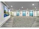 Spacious lobby area with carpet and elevators with bright blue doors for easy access to the property at 5855 Midnight Pass Rd # 303, Sarasota, FL 34242