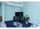 Community room featuring a large screen television with a decorative table, couch, and houseplant at 5855 Midnight Pass Rd # 303, Sarasota, FL 34242