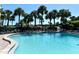 Resort-style pool and lounge area with chairs and landscaping at 5855 Midnight Pass Rd # 303, Sarasota, FL 34242