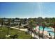 View from balcony of neighborhood pool and surrounding palm trees at 5855 Midnight Pass Rd # 303, Sarasota, FL 34242