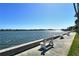 Water view with benches and green lawn at 5855 Midnight Pass Rd # 303, Sarasota, FL 34242