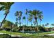 Tropical landscaping featuring lush greenery, palm trees, and a serene waterfall at 5855 Midnight Pass Rd # 303, Sarasota, FL 34242