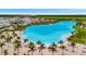 Breathtaking aerial view of the community lagoon, featuring white sand and clear turquoise water at 6027 White Mangrove Ln, Bradenton, FL 34210