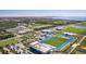 Expansive aerial view showcases campus with lush green spaces, sports facilities, and modern academic buildings at 6027 White Mangrove Ln, Bradenton, FL 34210
