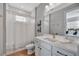 Bright bathroom with white cabinets, framed mirror, and modern decor at 6027 White Mangrove Ln, Bradenton, FL 34210