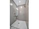 Contemporary bathroom featuring a gray tiled shower with a glass enclosure and modern fixtures at 6027 White Mangrove Ln, Bradenton, FL 34210